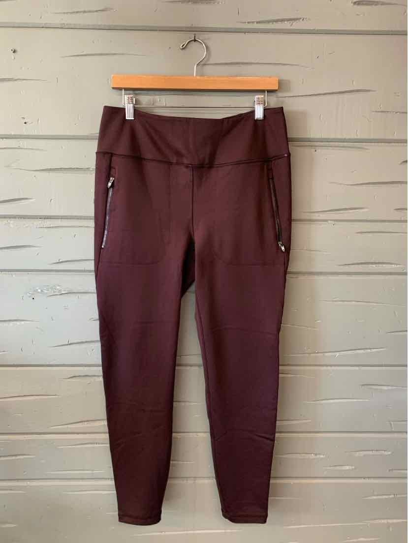 Maroon high-waisted leggings with front zip pockets and tapered legs, size XL.