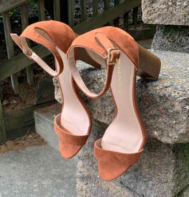 Brown suede open-toe block heel sandals with ankle straps and gold buckle closures.