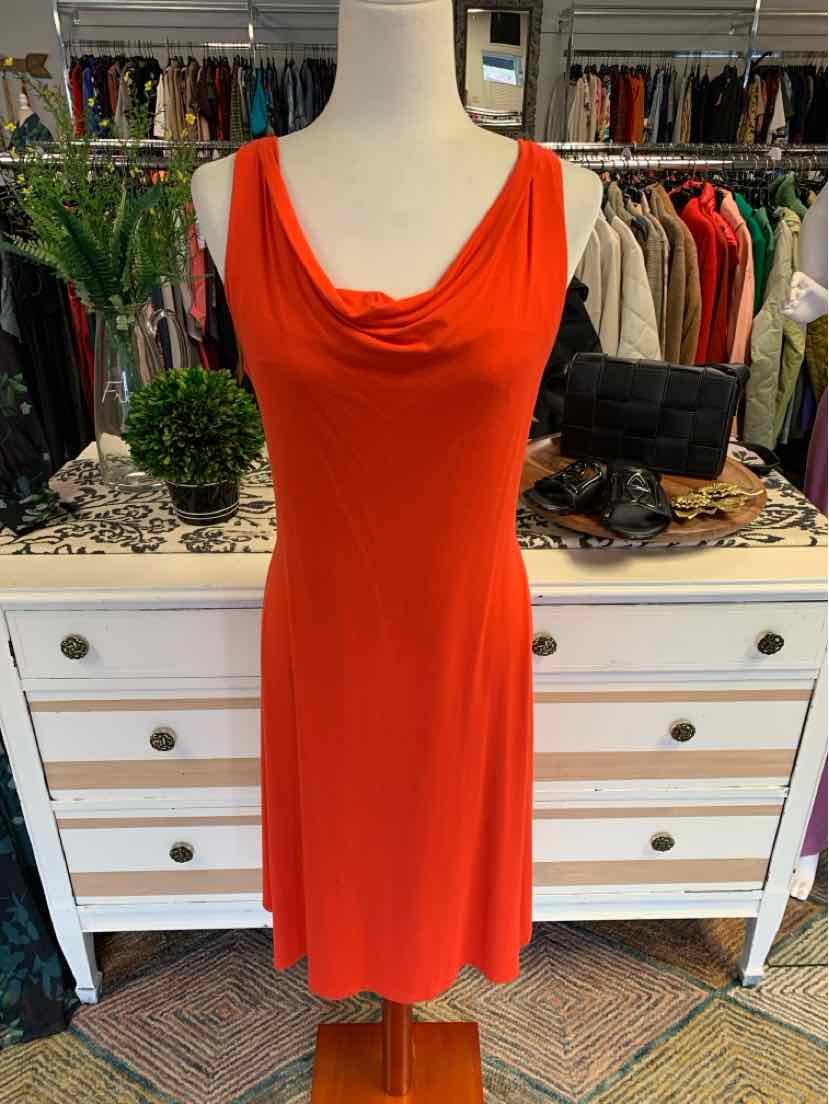 Sleeveless orange dress with cowl neckline and knee-length hem on mannequin.