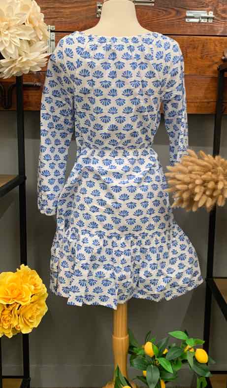 Blue and white floral long-sleeve dress with fitted waist and flared skirt on mannequin.