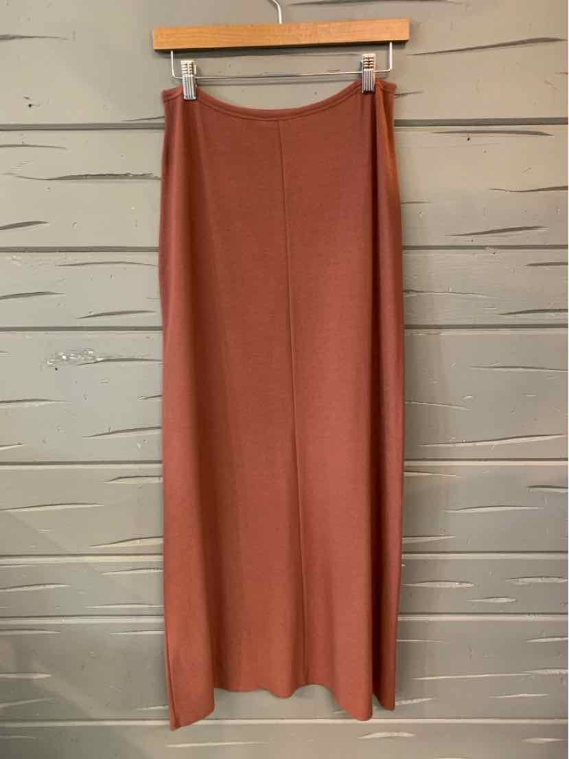 Mauve solid midi skirt with straight cut and subtle texture hanging on wooden hanger.