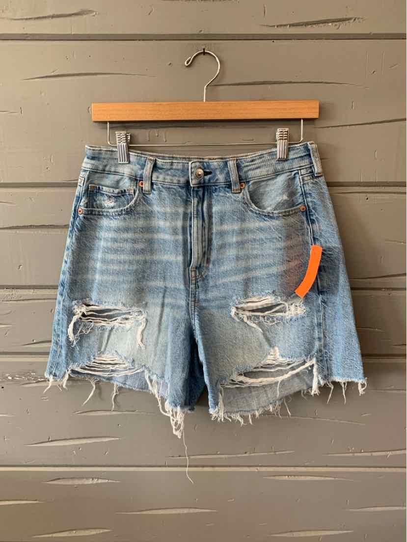 Light blue distressed denim shorts with frayed hems and ripped details, size 6.