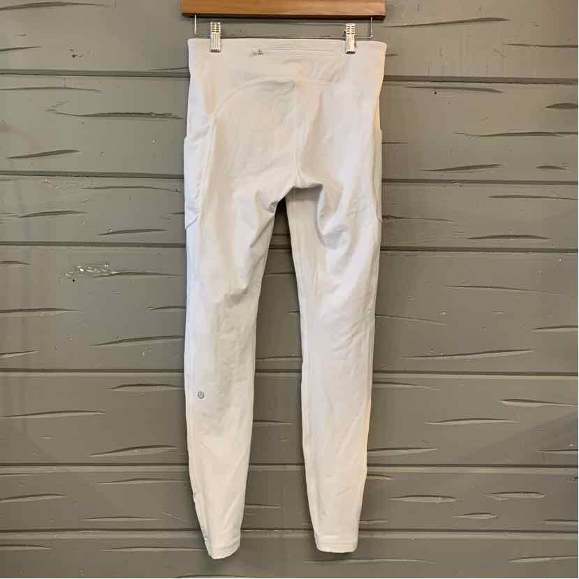 White high-waist Lululemon leggings with subtle logo near ankle, size 6.