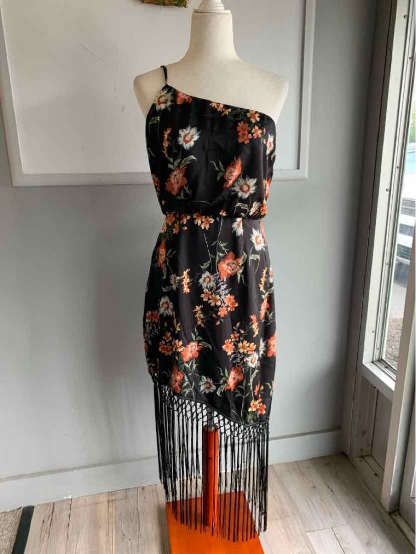 Black one-shoulder midi dress with orange floral print and long fringe hem.