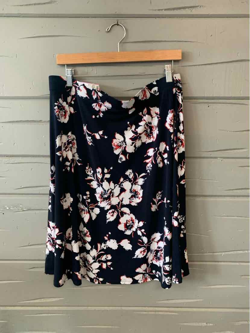 Black floral A-line skirt with white and pink blossoms, midi length, lightweight fabric.