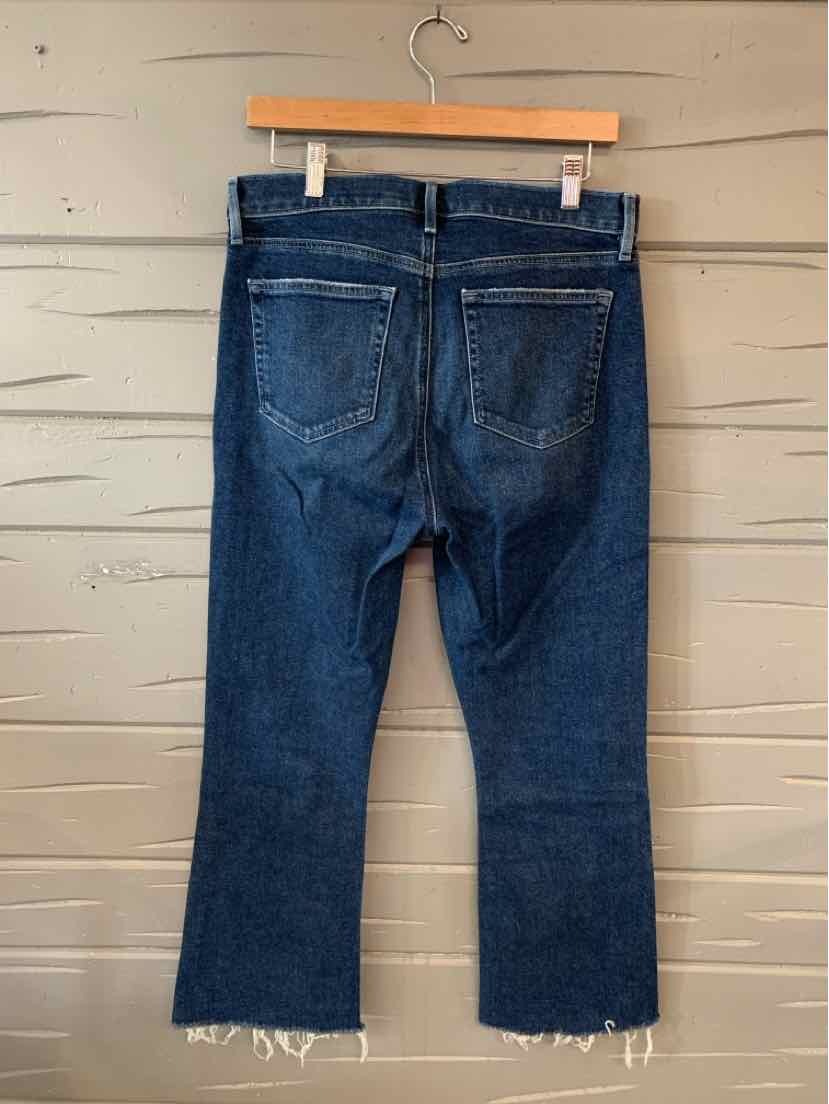 Dark blue denim jeans with a cropped, frayed hem and back patch pockets, size 8.