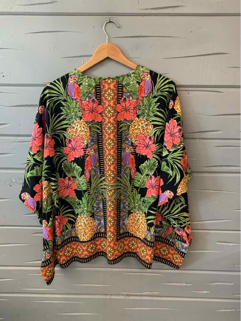 Colorful tropical print kimono with pineapples, pink flowers, green leaves, and geometric border designs.