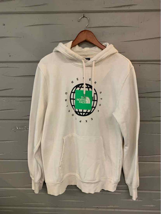 White hoodie with a green and black circular graphic on the front, featuring a kangaroo pocket and drawstring hood.