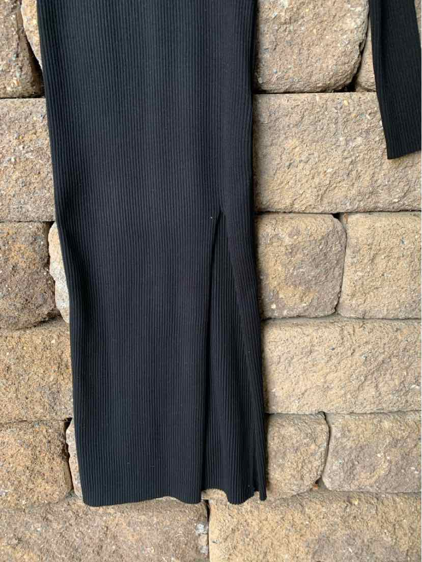 Black fitted midi dress with long sleeves and a small front slit at the hem.
