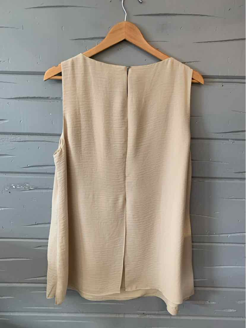 Tan sleeveless blouse with a textured fabric and a straight hem hanging on a wooden hanger.