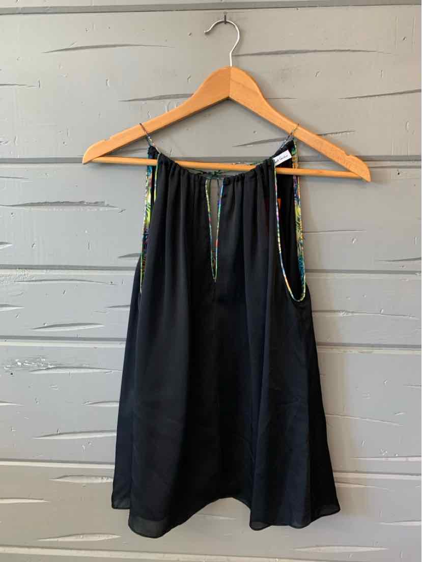 Black silk sleeveless blouse with a multicolored patterned collar and front tie on a wooden hanger.