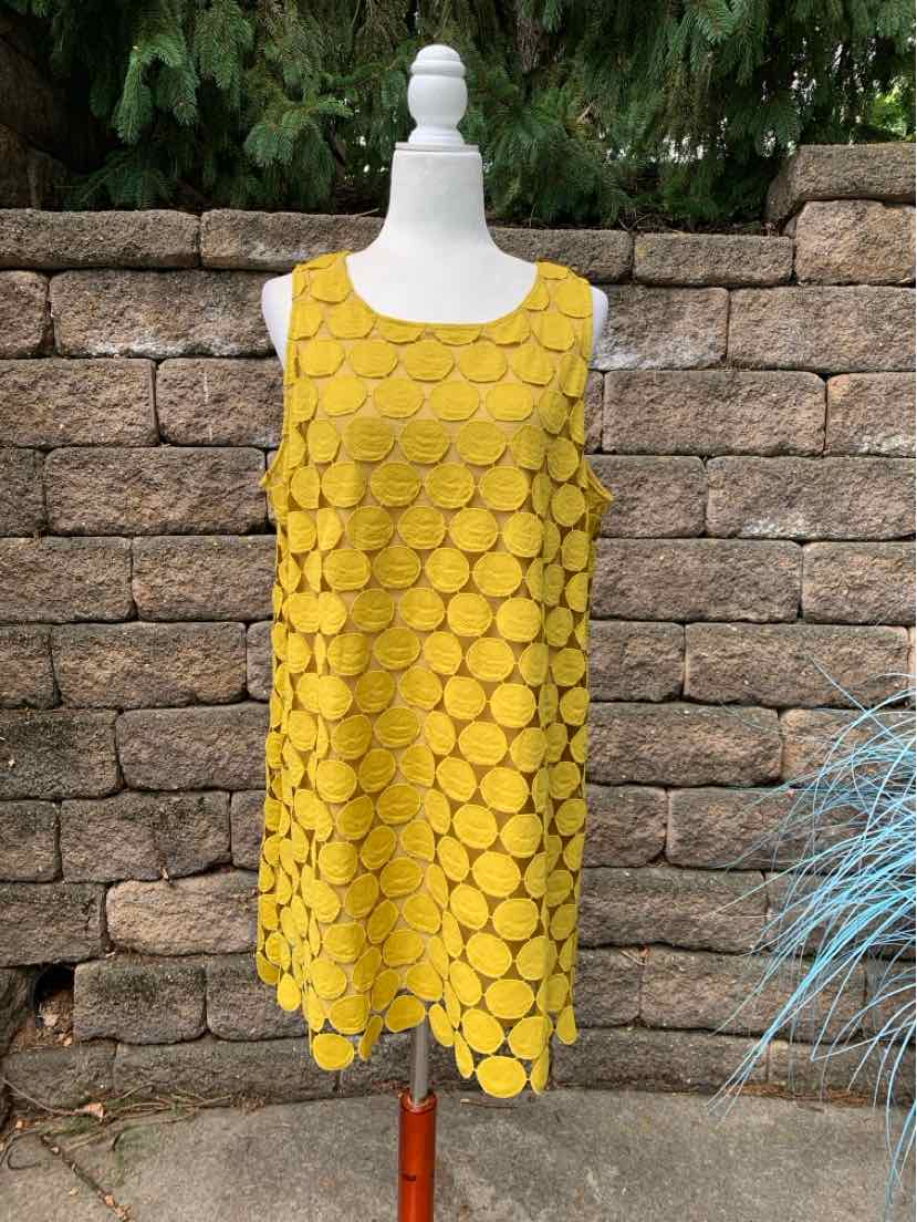 Sleeveless mustard yellow dress with textured circular pattern, scoop neckline, and loose fit.