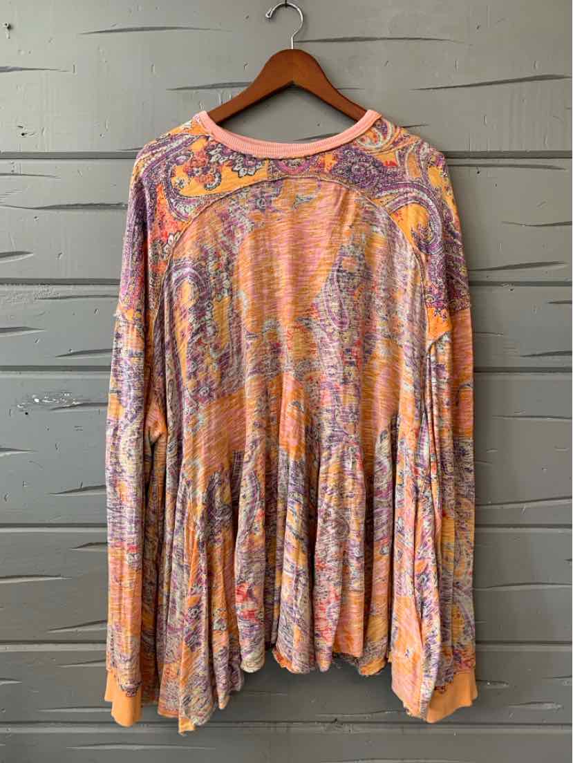 Flowy long-sleeve top with orange paisley print and gathered waist detailing.