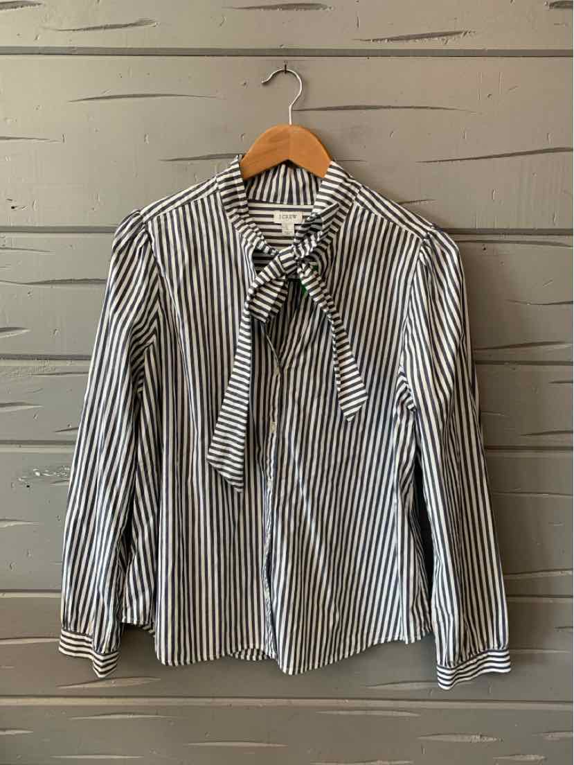 Long-sleeve blouse with black and white vertical stripes, featuring a tie-neck bow and buttoned cuffs.