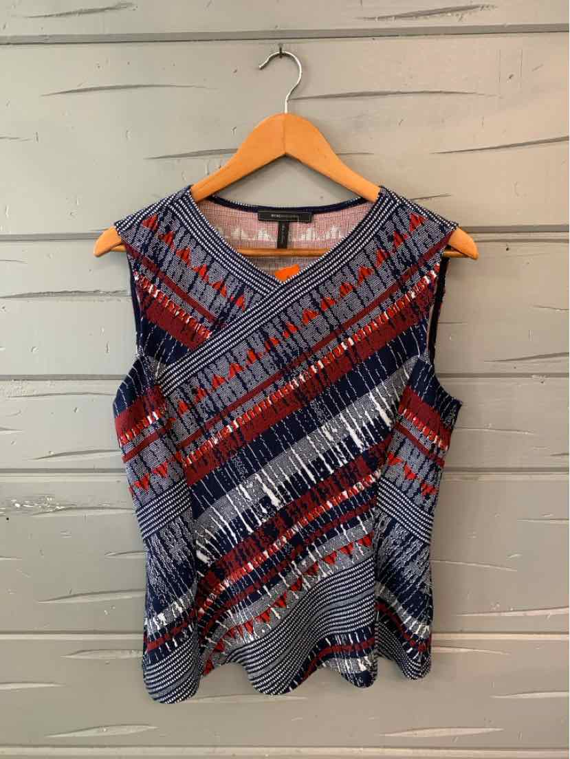Sleeveless knit top with geometric diagonal stripes in navy, red, gray, and white on a fitted silhouette.