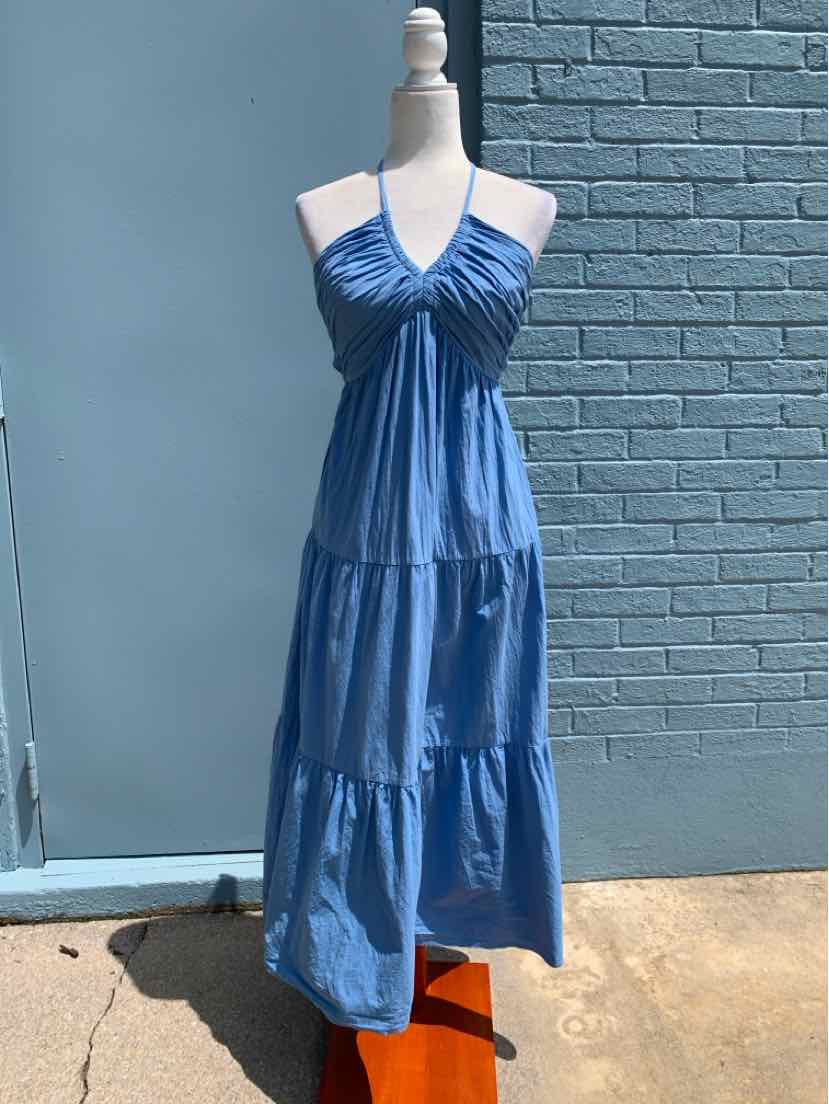 Blue sleeveless midi dress with ruched bodice, halter neck, and tiered skirt on a mannequin.