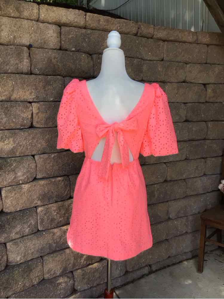 Coral pink eyelet dress with puff sleeves, open back, and tied bow at waist, size 0.