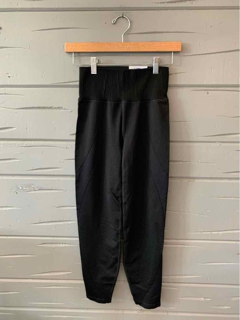 Black high-waisted slim fit jogger pants with ribbed elastic waistband and cuffed ankles.