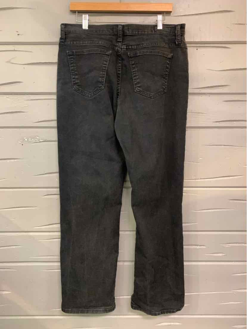 Black denim jeans in size 14 with back pockets and a straight leg cut hanging on a wooden hanger.