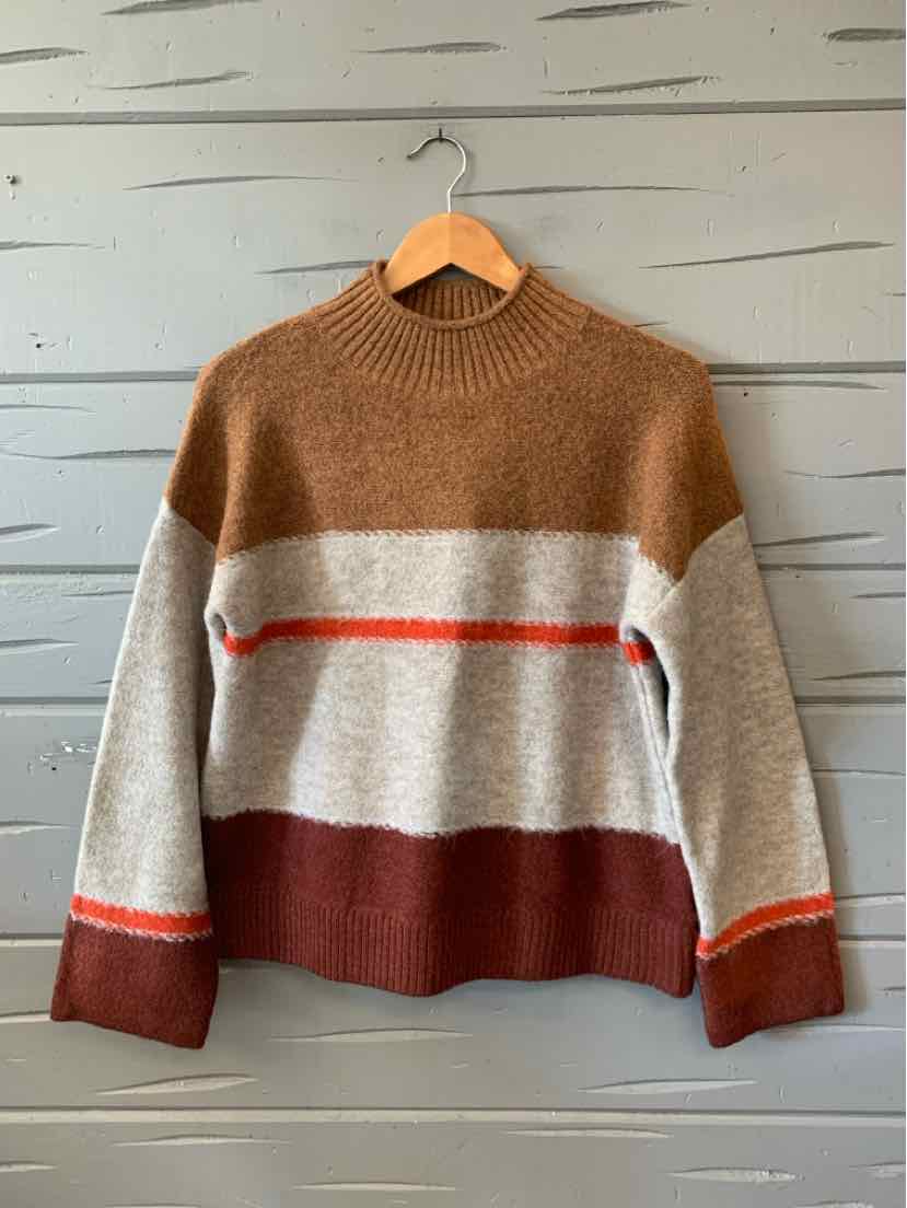 Color-blocked knit sweater in brown, beige, and rust with horizontal red stripes and ribbed collar and cuffs.