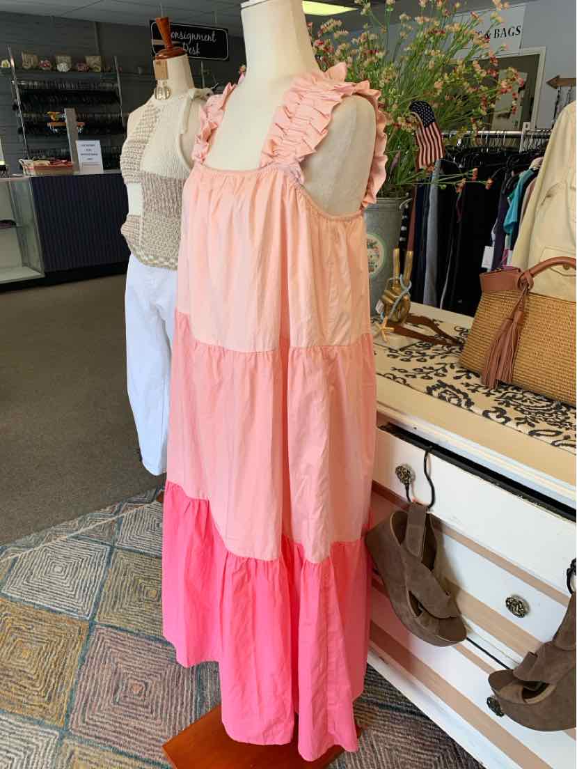 Sleeveless tiered dress with ruffled straps in light pink, medium pink, and bright pink color blocks.