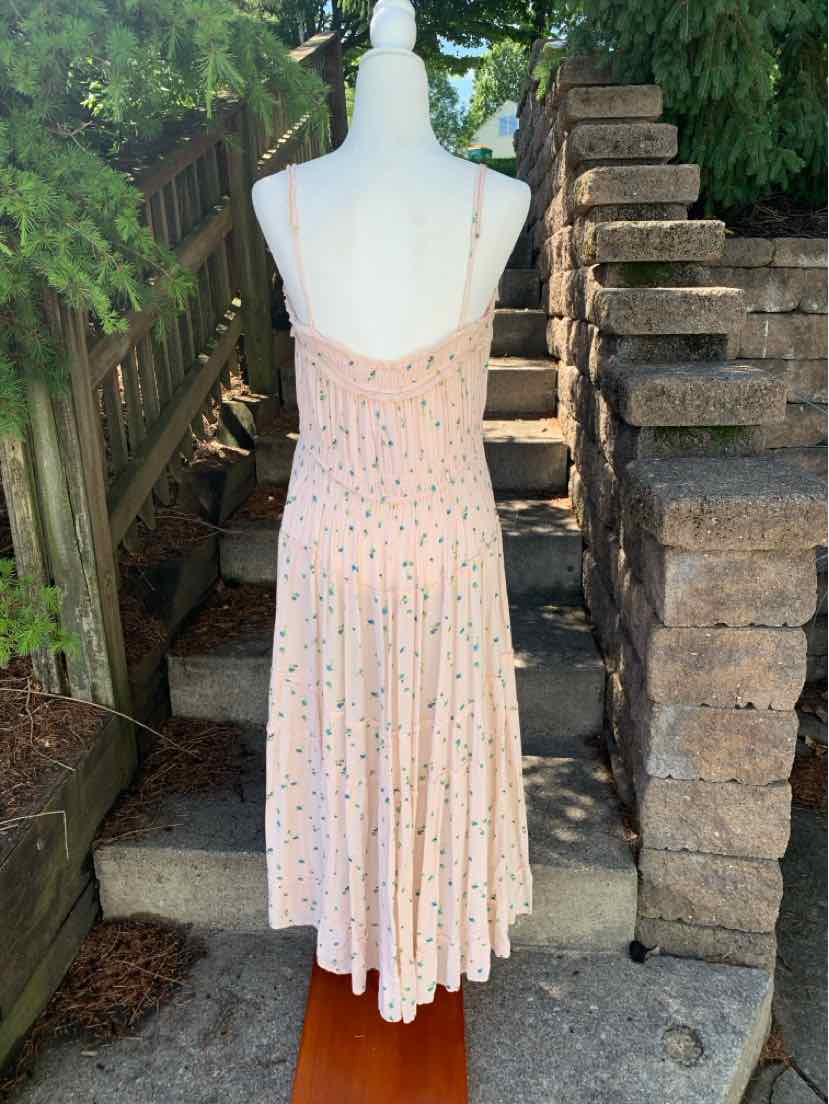 Light pink floral midi dress with thin adjustable straps and pleated skirt.