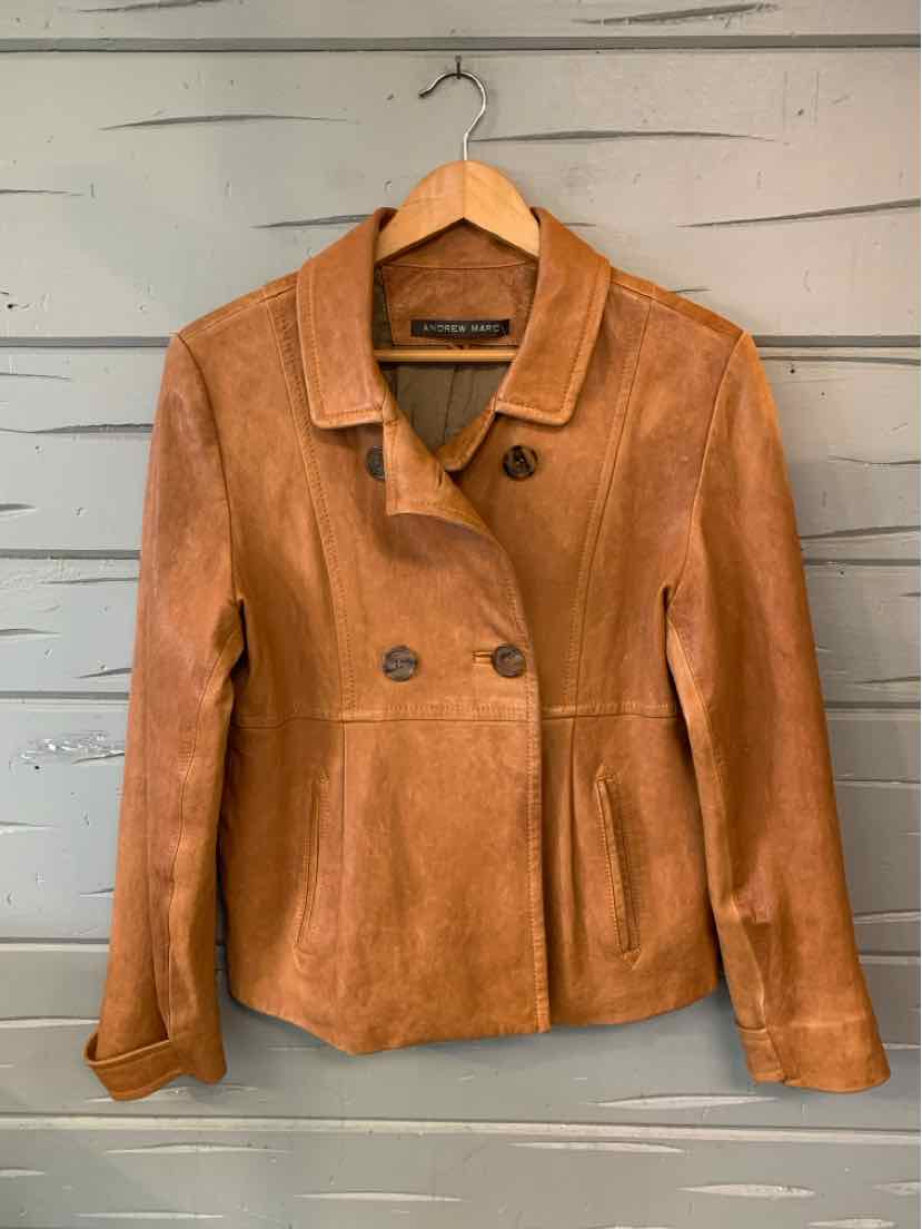 Tan leather Andrew Marc jacket with a notched collar, double-breasted buttons, and long sleeves.