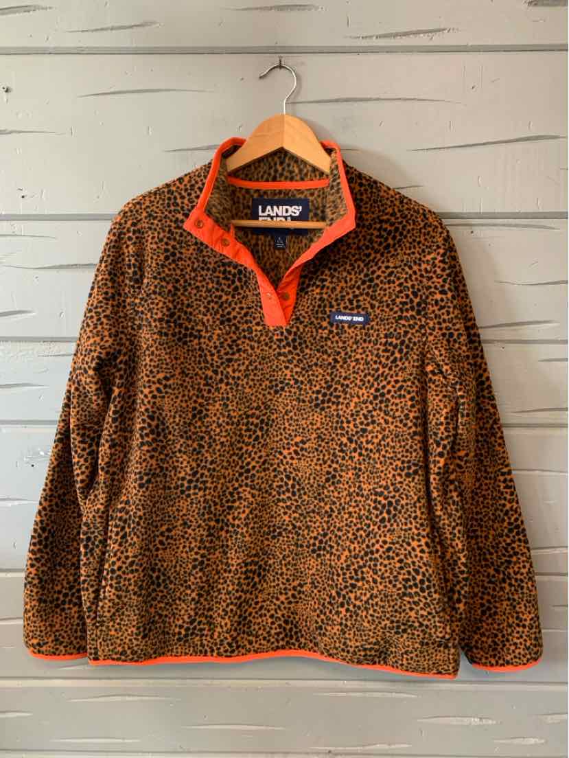 Brown and black leopard print fleece pullover with orange collar and quarter-zip front.