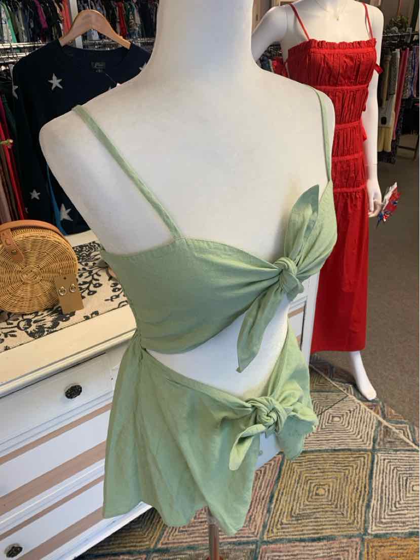 Sage green two-piece dress with knotted front crop top and matching high-waist skirt.