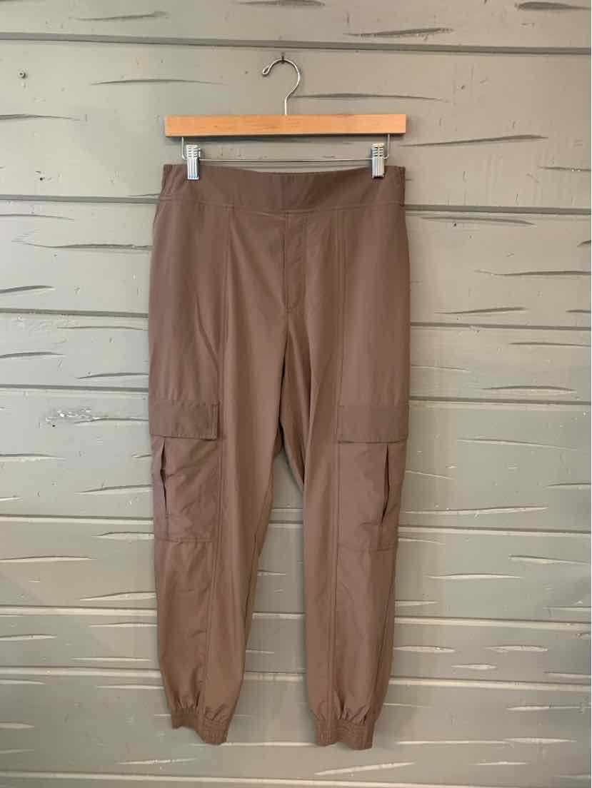 Brown high-waist jogger pants with elastic cuffs and side cargo pockets.