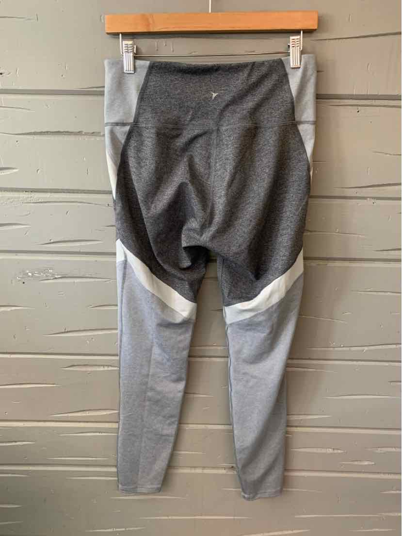 Two-tone gray athletic leggings with darker gray waistband and upper back panel, lighter gray lower legs, and white diagonal