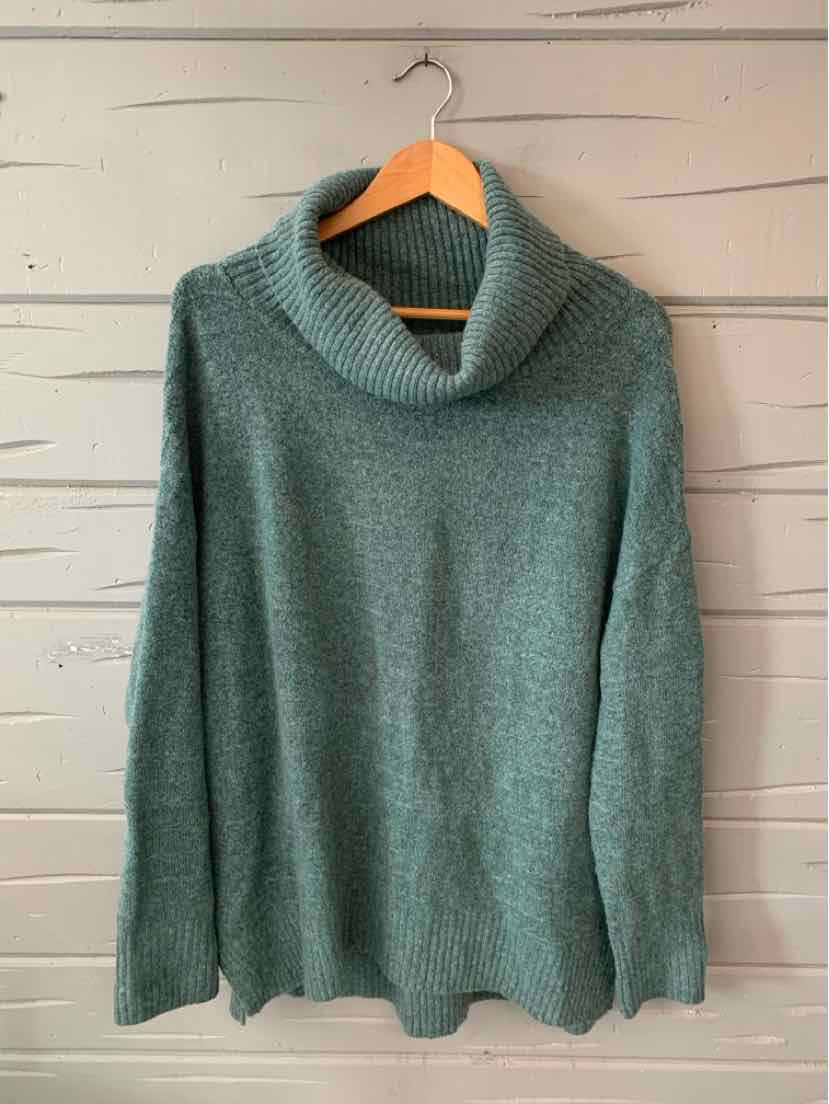 Soft green knit sweater with a relaxed fit and wide cowl neck collar on a hanger.