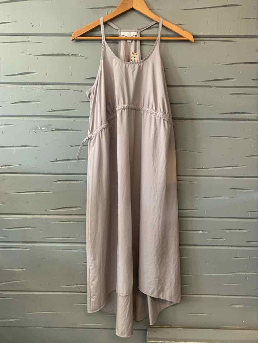 Beige sleeveless midi dress with adjustable side ties, scoop neckline, and relaxed fit on wooden hanger.