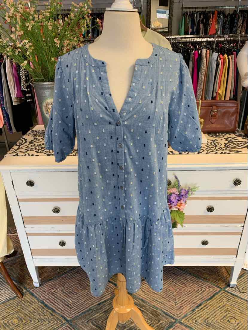 Blue short-sleeve dress with white embroidered dots and tiered hem on mannequin.