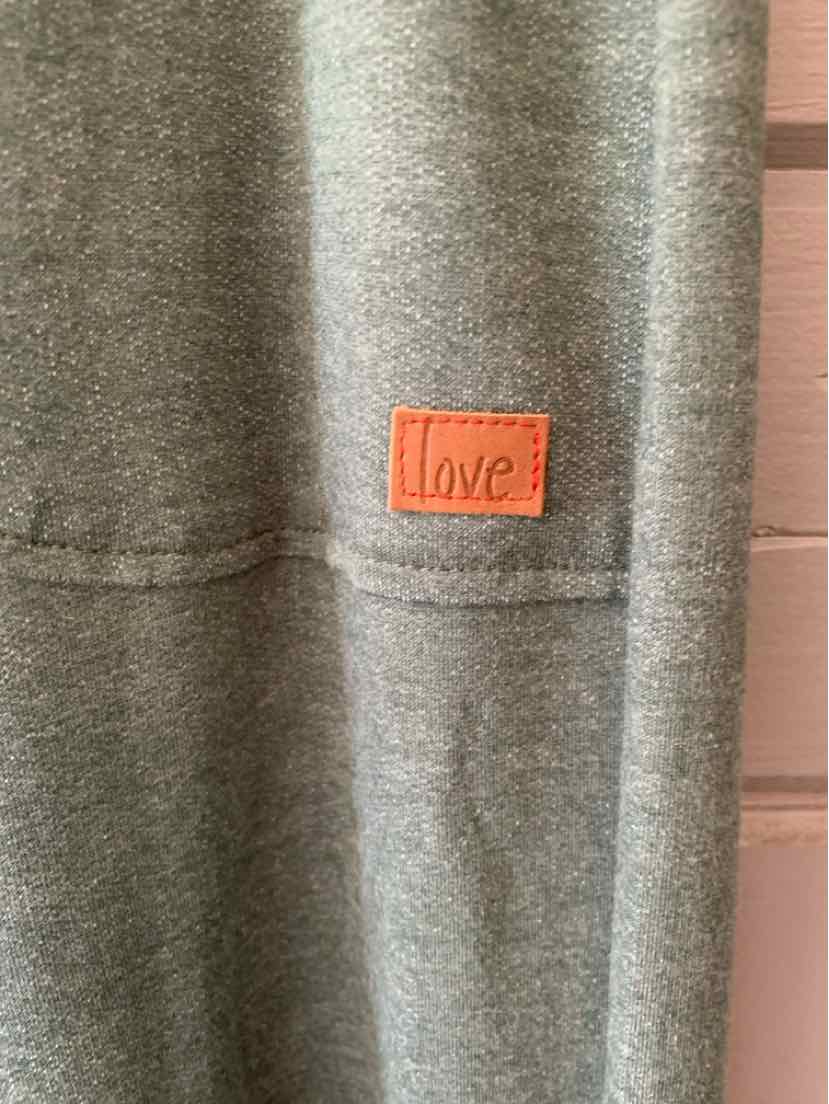 Heather gray sweatshirt with stitched horizontal seam and small orange patch labeled "love".