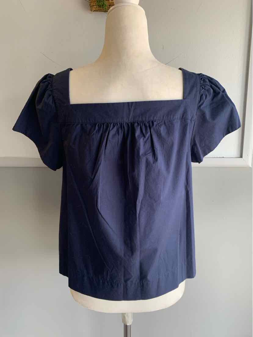 Navy blue short-sleeve blouse with square neckline and gathered detail at front.