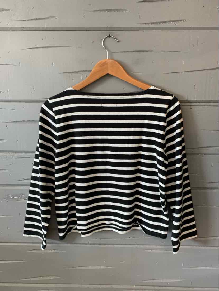 Black and white horizontal striped long-sleeve shirt with a boat neckline on a wooden hanger.