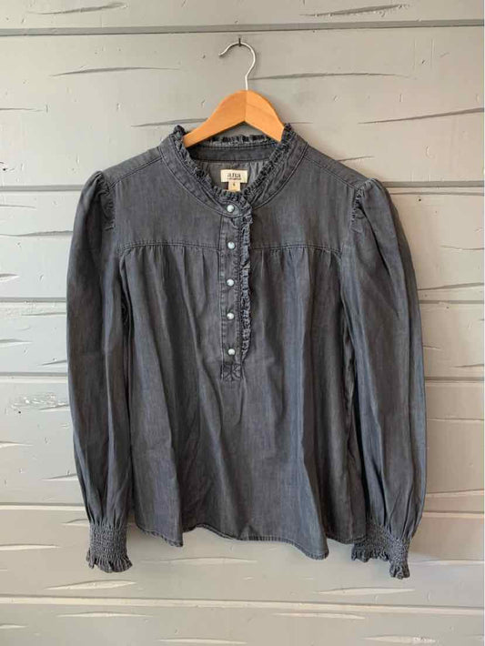 Dark gray long-sleeve blouse with ruffled collar and buttoned front placket.