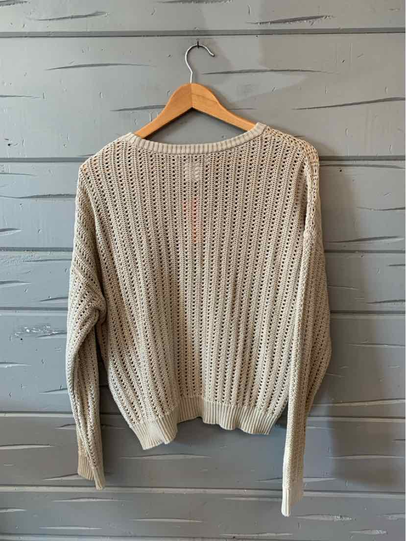 Tan knit long-sleeve sweater with ribbed cuffs and hem, relaxed fit, size large.