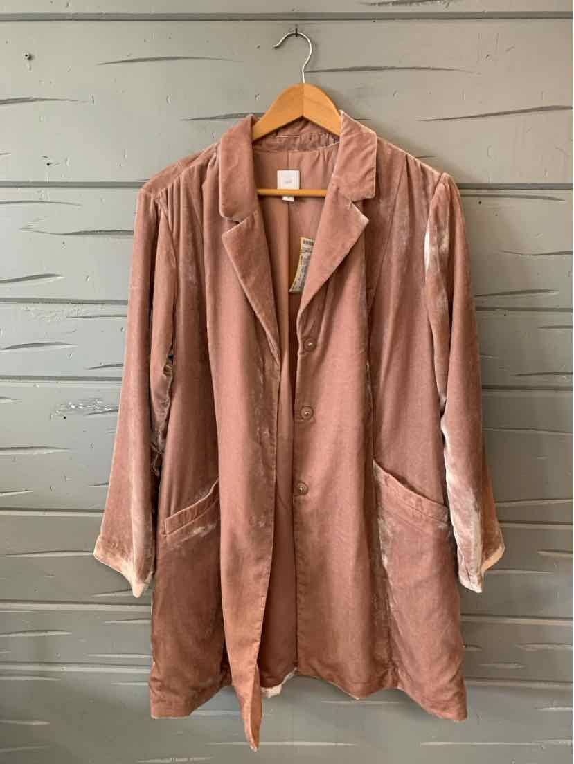 Mauve velvet long blazer with lapel collar, two front pockets, and relaxed fit hanging on wooden hanger.
