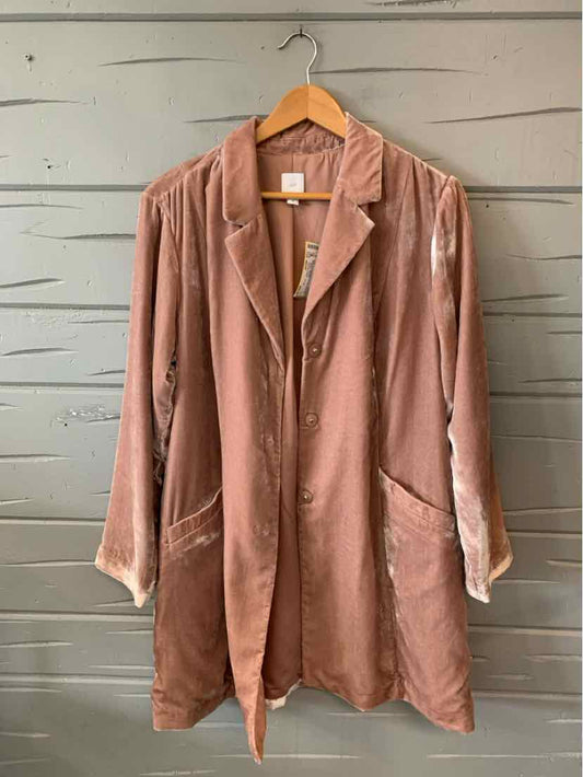 Mauve velvet long blazer with lapel collar, two front pockets, and relaxed fit hanging on wooden hanger.