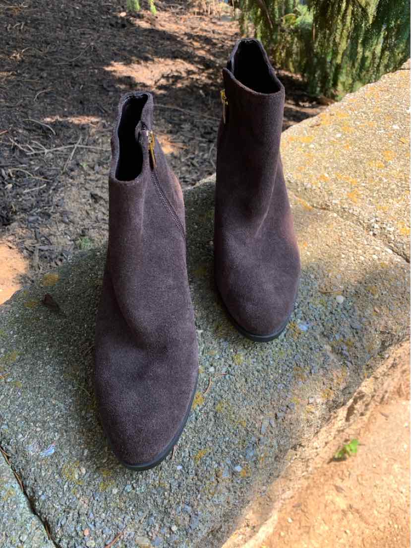 Dark brown suede ankle boots with pointed toes and side zipper closures.
