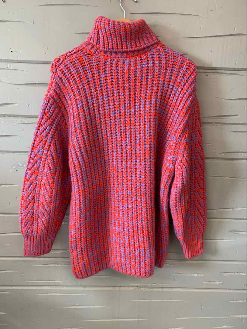 Chunky knit turtleneck sweater in bright red with blue stripes and oversized sleeves.