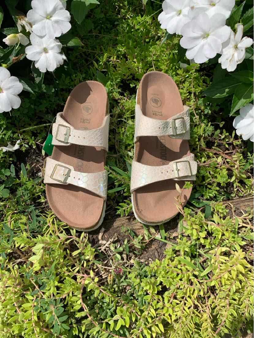 Beige two-strap Birkenstock sandal with adjustable buckles and cork footbed, size 37.