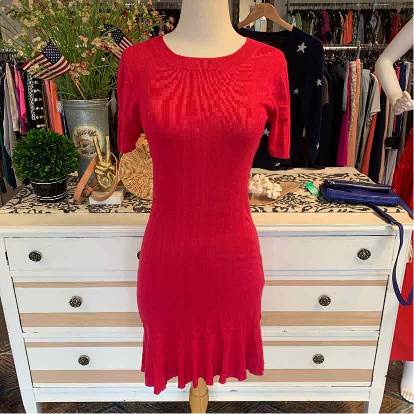 Fuchsia knit dress with long sleeves and scalloped hem on mannequin.