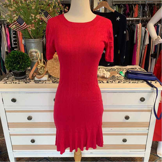 Fuchsia knit dress with long sleeves and scalloped hem on mannequin.
