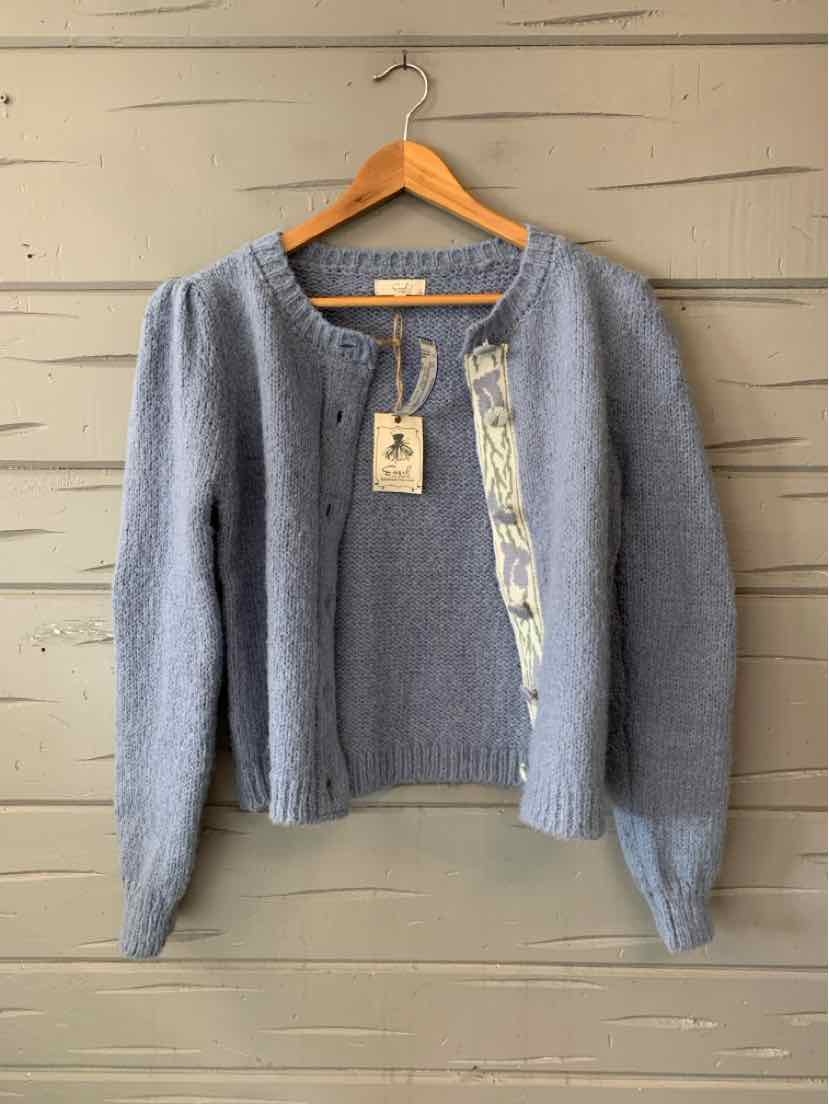 Gray knit cardigan with a round neckline, button front, and patterned trim along the placket and pockets.