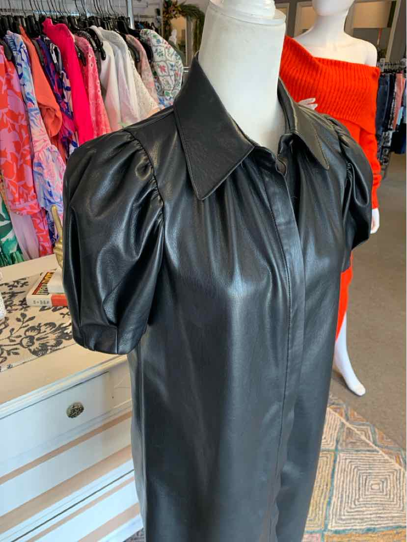 Black faux leather mini dress with puffed short sleeves and a pointed collar.