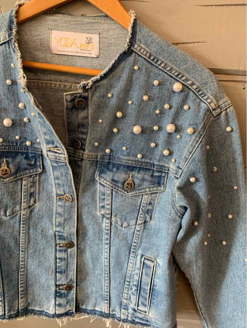 Light blue denim jacket with pearl embellishments scattered across front and sleeves, button-front closure, and flap chest.