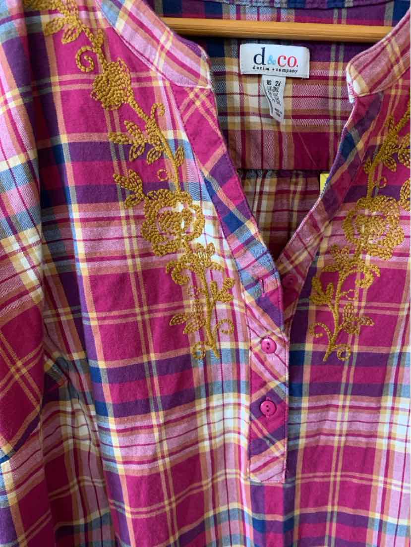 Pink and purple plaid shirt with yellow floral embroidery along the button placket and collar.